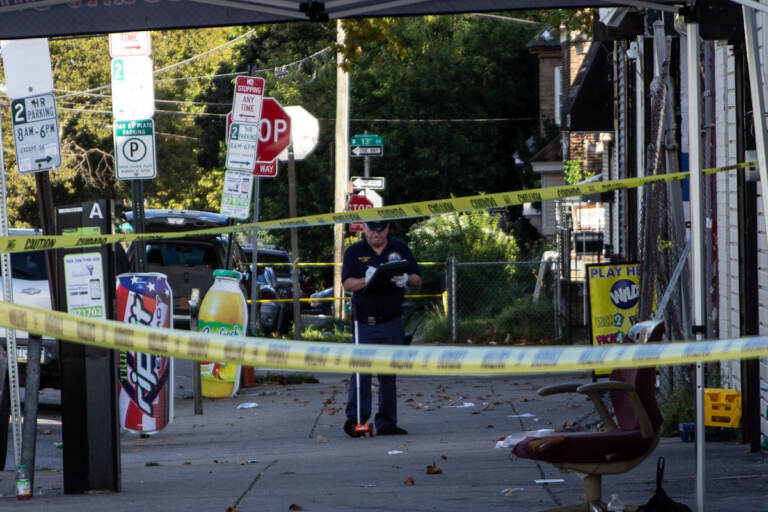 A crime scene investigator works on the scene of a mass shooting