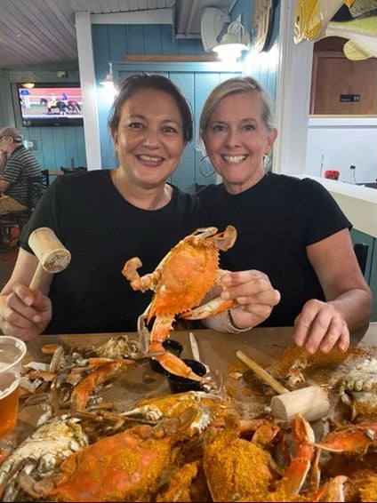 Carrie Leishman (right) says dining out is "not just a meal." She recently had feasted on crabs with former college roommate Arlene Piarulli, who was visiting Bethany Beach from her home in Italy