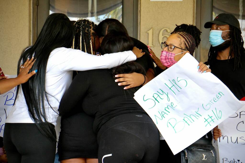 Bahir Green’s sisters and supporters comfort each other during a press conference