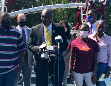 Attorney Ben Crump joined by Micah “Dew” Tennant’s parents Samuel Dunmore (left) and Angela Tennant along with Micah’s aunt Monica Tennant (far right) as he announces a lawsuit against the Pleasantville Board of Education and NJSIAA. (P. Kenneth Burns/WHYY) 