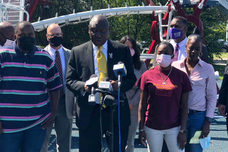 Attorney Ben Crump joined by Micah “Dew” Tennant’s parents Samuel Dunmore (left) and Angela Tennant along with Micah’s aunt Monica Tennant (far right) as he announces a lawsuit against the Pleasantville Board of Education and NJSIAA. (P. Kenneth Burns/WHYY) 