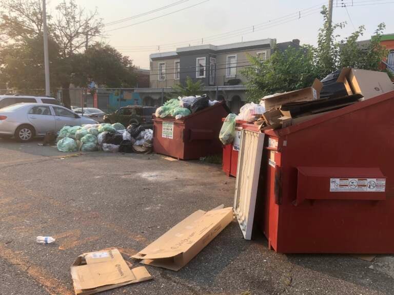 Lewis Elkin Elementary School with piles of garbage in its parking lot on Monday morning. (Emily Rizzo / WHYY)