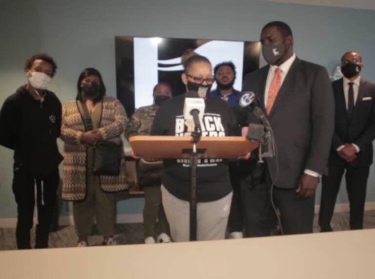 Kevin Mincey (right) comforts Rachel Briggs (left) as she speaks at a press conference