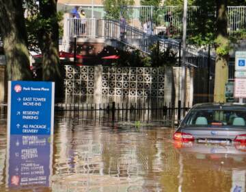 A car is swamped at Park Towne Place apartments off 22nd Street near the Vine Street Expressway