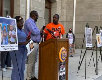 Kimberly Kamara and her husband Kesselle, pictured with Council member Kenyatta Johnson, lost their 23-year-old son Niam Johnson-Tate to gun violence in 2017. (Aaron Moselle, WHYY)