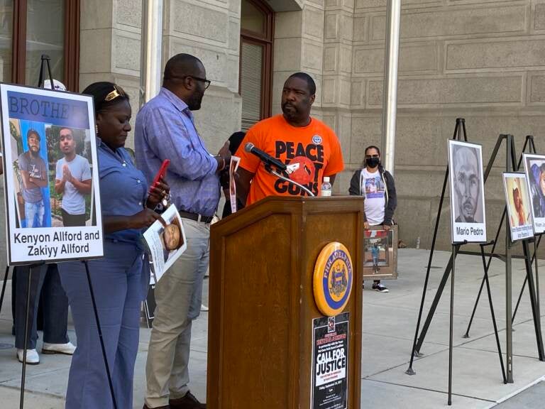 Kimberly Kamara and her husband Kesselle, pictured with Council member Kenyatta Johnson, lost their 23-year-old son Niam Johnson-Tate to gun violence in 2017. (Aaron Moselle, WHYY)