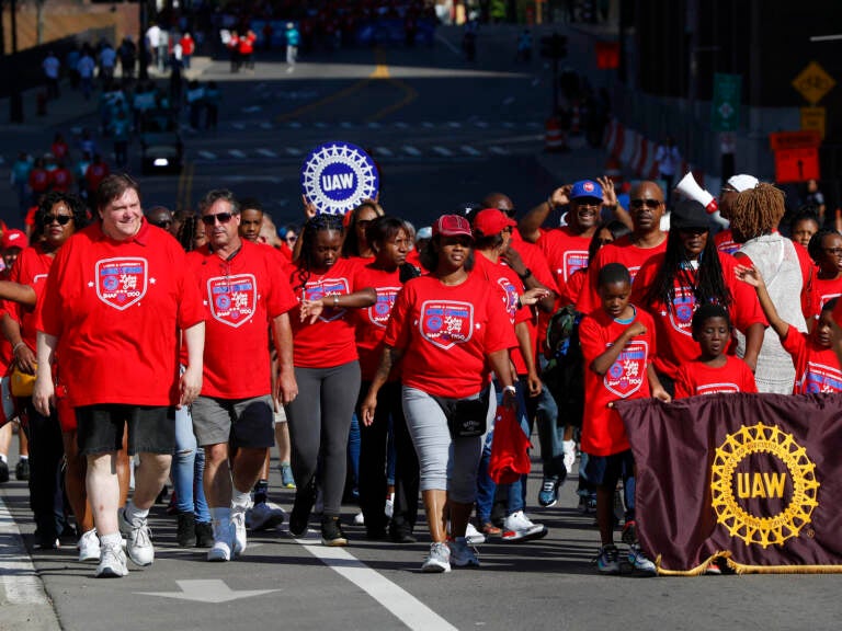 United Auto Workers members walk in the Labor Day parade