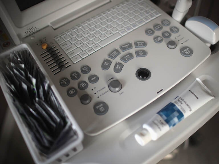 An ultrasound machine sits next to an exam table