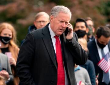 White House Chief of Staff Mark Meadows speaks on his phone as he waits for US President Donald Trump to depart the White House on October 30, 2020 in Washington, D.C.