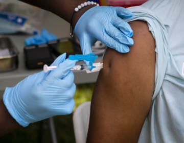 A person receives a dose of the Johnson & Johnson COVID-19 vaccine
