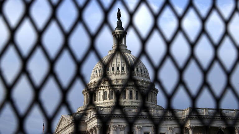 The U.S. Capitol Dome is seen through security fencing in May. Similar barriers will be in place on Saturday, when a demonstration is planned in support of people charged for the Jan. 6 pro-Trump attack on the Capitol. (Chip Somodevilla/Getty Images)