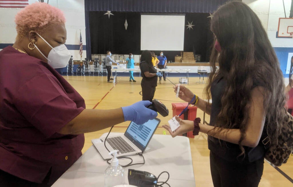 Amy submits her saliva sample for PCR analysis