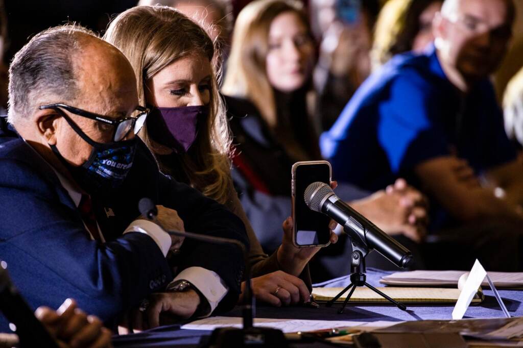 Jenna Ellis sits next to Rudy Giuliani at a meeting in Gettysburg