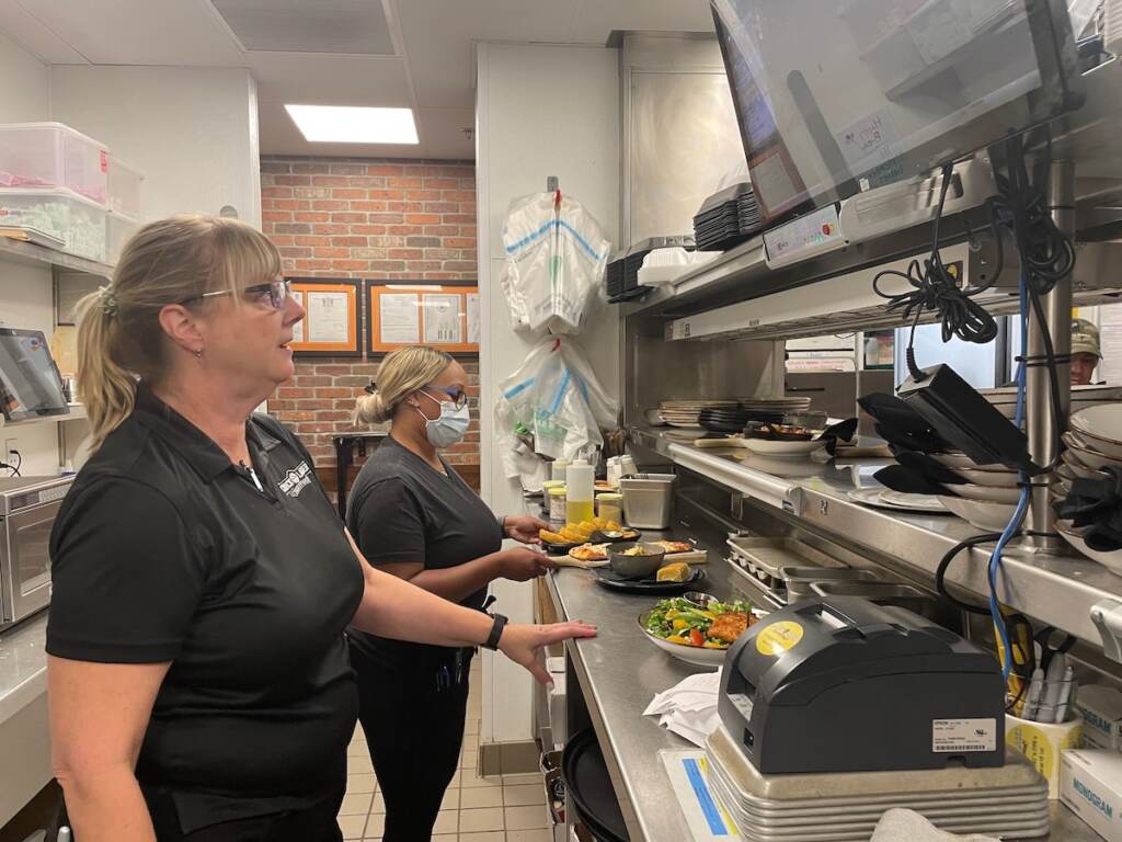 Dawn Joyce (left) and Sam Melton organize orders for Chuck Lager's customers