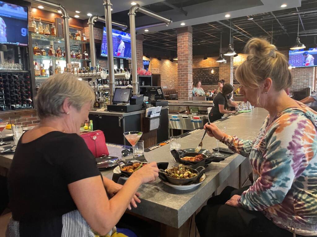 From left, Breda Buckley and Joyce Melton enjoy drinks and appetizers