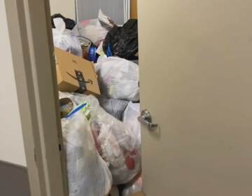 A trash room is pictured with overflowing trash