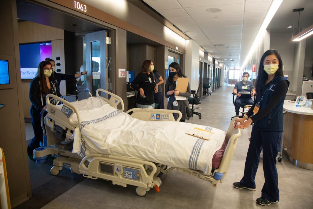 A team of medical professionals rehearse how to bring a patient in a care bed to another floor during a dress rehearsal of different patient scenarios in the new Pavilion building at the Hospital of the University of Pennsylvania
