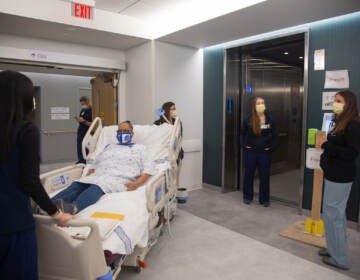 A team of medical professionals rehearse how to bring a mock patient in a care bed to another floor during a dress rehearsal of different patient scenarios in the new Pavilion building at the Hospital of the University of Pennsylvania