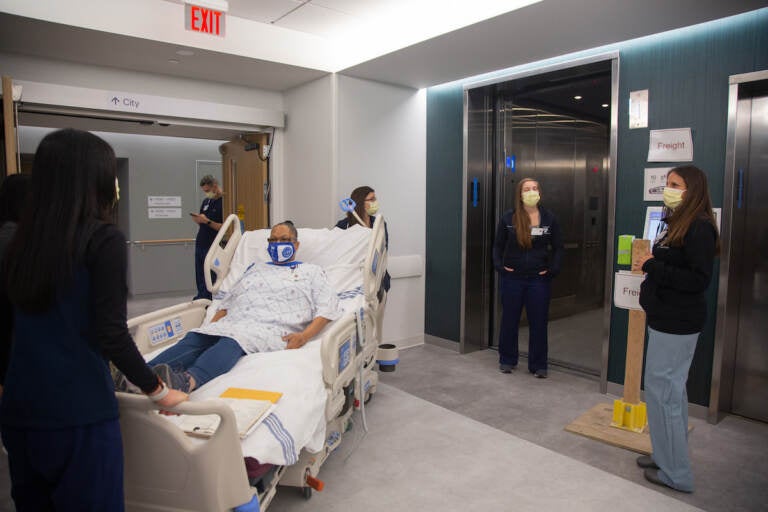 A team of medical professionals rehearse how to bring a mock patient in a care bed to another floor during a dress rehearsal of different patient scenarios in the new Pavilion building at the Hospital of the University of Pennsylvania