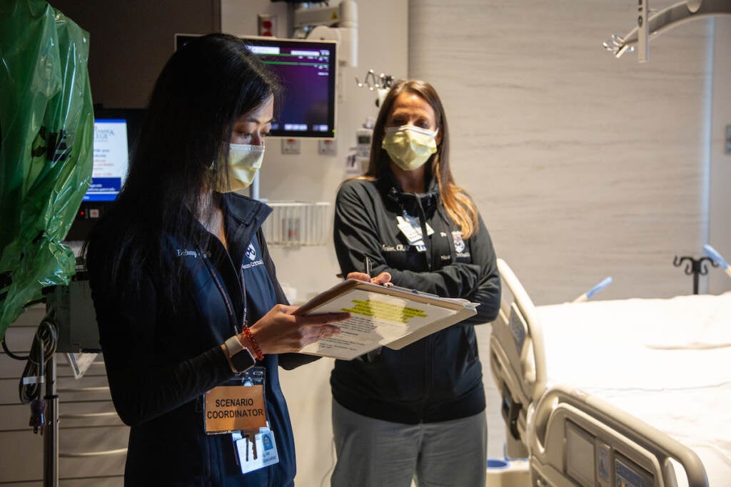 Bethany Young, RN, jots down some notes in response to a drill that was just performed during a dress rehearsal of different patient scenarios in the new Pavilion building at the Hospital of the University of Pennsylvania