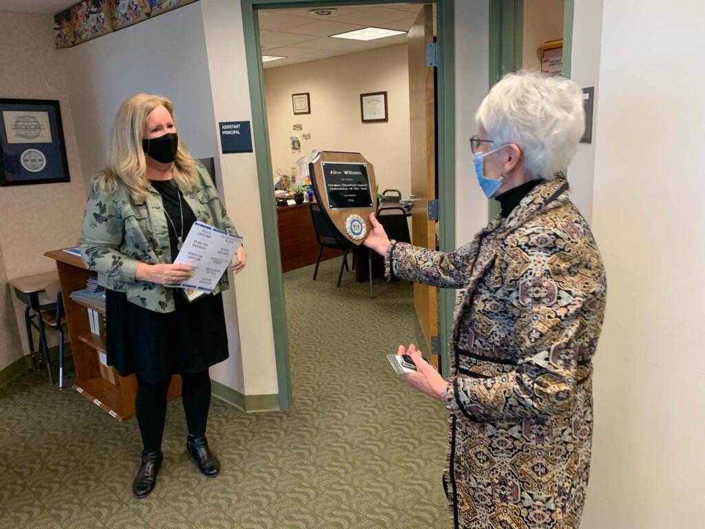 Susan Bunting (right) congratulates Alice Williams, who in 2020 was named State Educational Support Professional of the Year