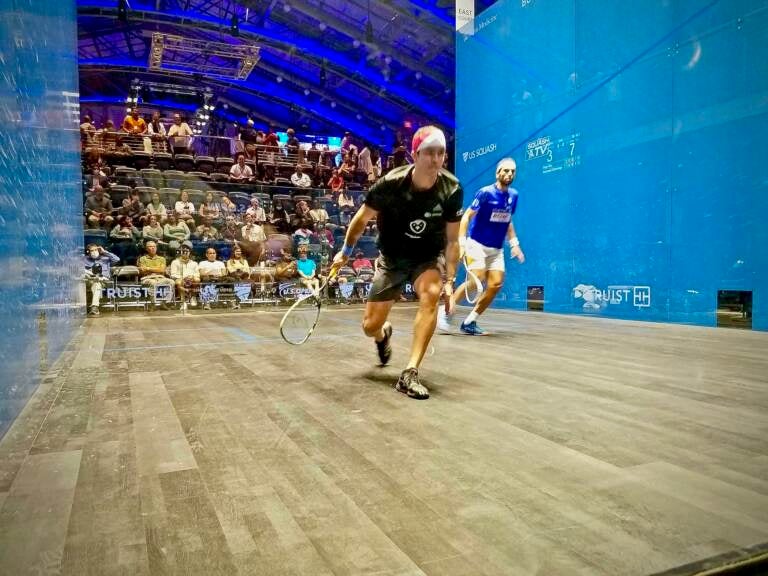 Diego Elías of Peru (in black) plays against Mohamed el Shorbagy of Egypt (in blue), in the US Open for squash at the new Arlen Spector Squash Center on the campus of Drexel University