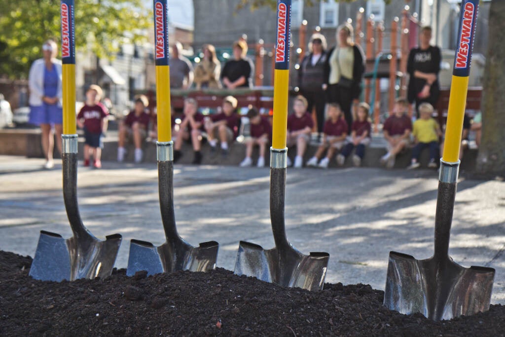 Students from Our Lady of Port Richmond School wait to help shovel dirt at the ceremonial groundbreaking of the new Glavin playground