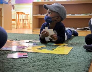 Gabriel Watson, 3, works on a puzzle during his preschool class at Children's Playhouse Whitman in South Philadelphia. (Emma Lee/WHYY)