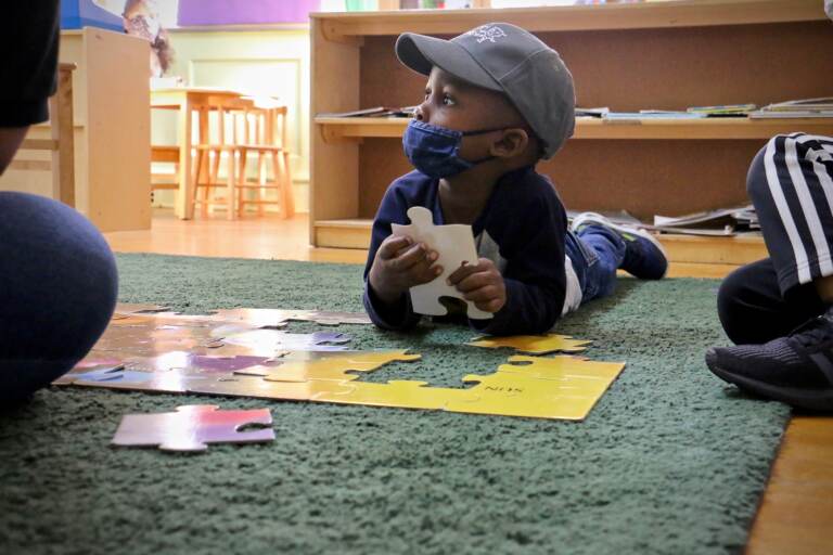 Gabriel Watson, 3, works on a puzzle during his preschool class at Children's Playhouse Whitman in South Philadelphia. (Emma Lee/WHYY)