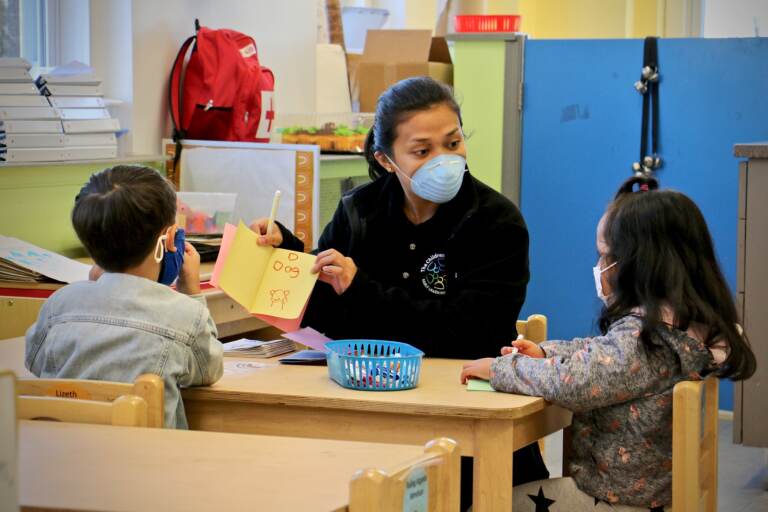 Ghealze Bernstein works with preschool students at Children's Playhouse Whitman in South Philadelphia. (Emma Lee/WHYY)