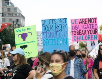 Signs are held up as marchers walk from the art museum to Philadelphia City Hall as part of an abortion rights rally held in Philadelphia, PA on Saturday, Oct. 2, 2021. Hundreds gather in Philadelphia as part of 