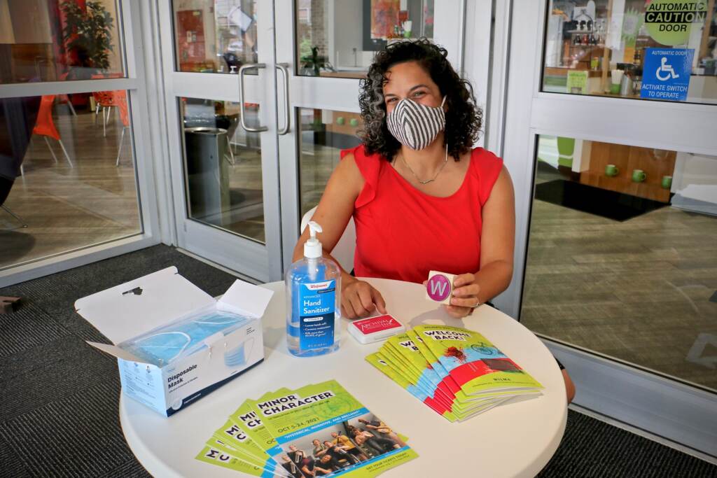 Leigh Goldenberg wears a face mask inside an office