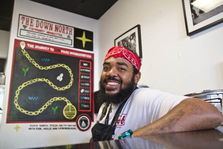 Michael Carter smiles from behind the counter