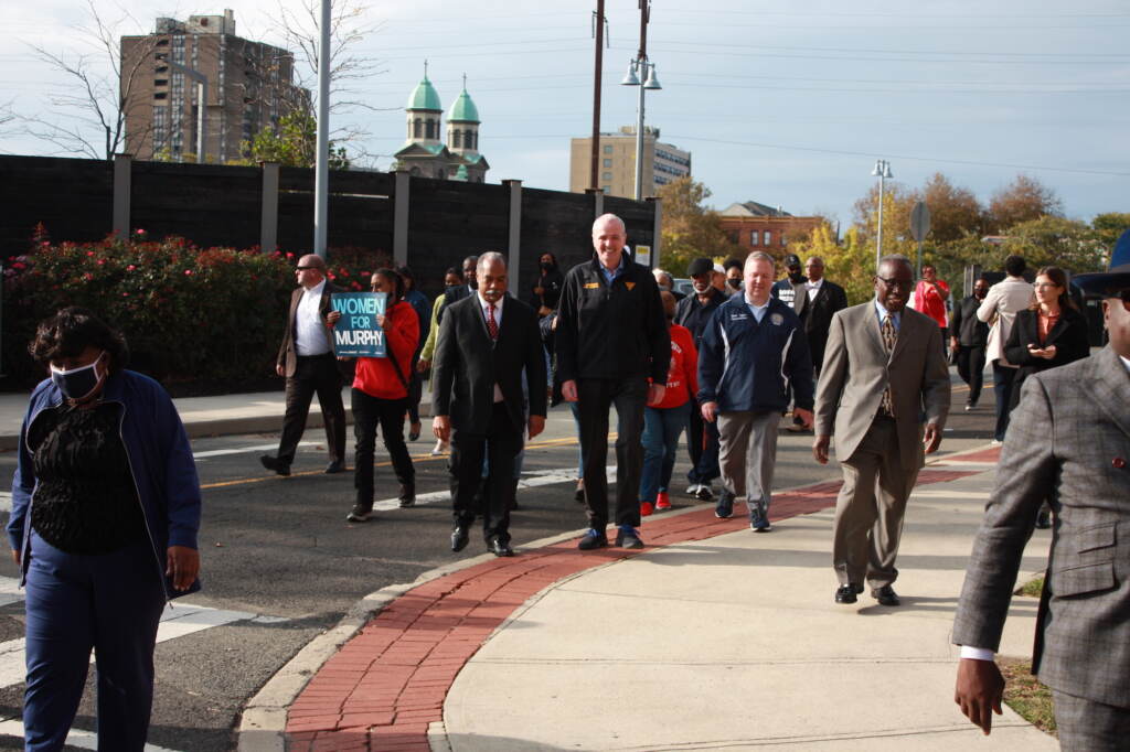 New Jersey Gov. Phil Murphy (center) walks with a group of people from a Souls to the Polls rally