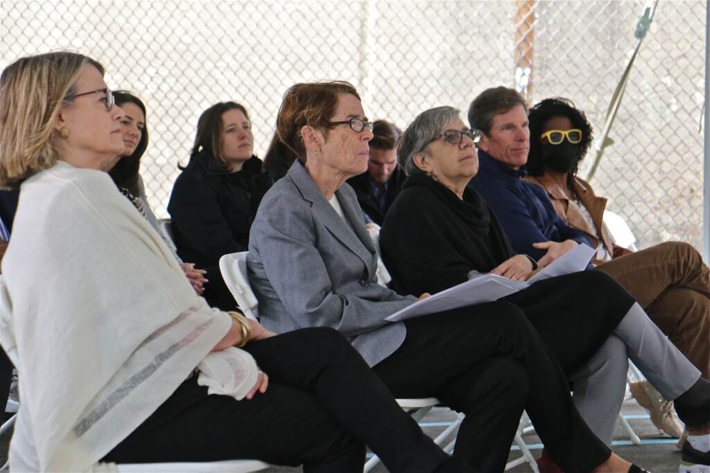 Sister Mary Scullion listens to speakers while sitting in a crowd