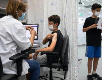 A young Israeli receives a Pfizer-BioNTech COVID-19 vaccine