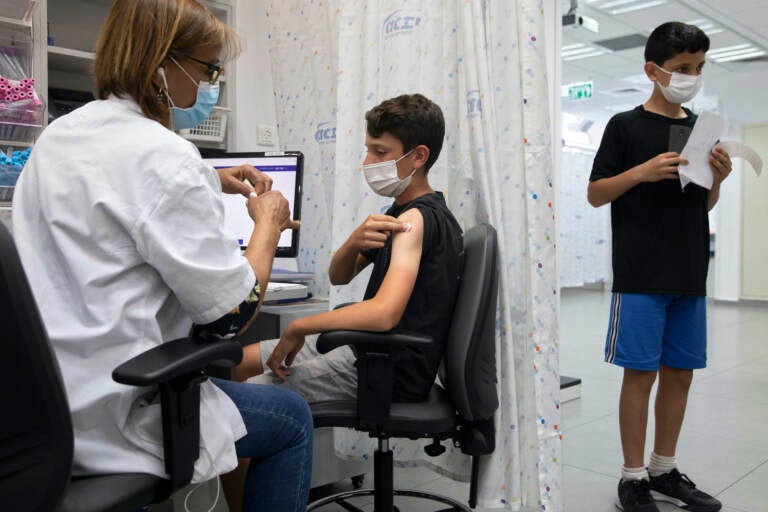 A young Israeli receives a Pfizer-BioNTech COVID-19 vaccine