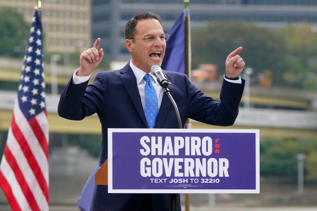 Josh Shapiro speaks to a crowd from a podium