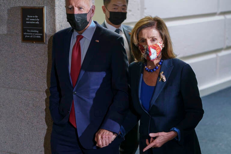 President Joe Biden and Speaker of the House Nancy Pelosi, D-Calif., talk in a basement hallway of the Capitol after meeting with House Democrats to rescue his his $3.5 trillion government overhaul and salvage a related public works bill, in Washington, Friday, Oct. 1, 2021
