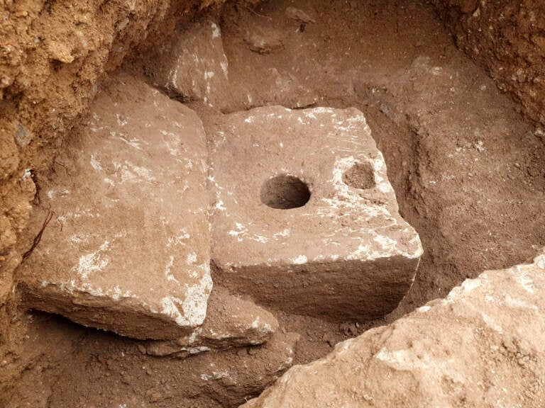 In this photo provided by Israel Antiquities Authority shows a rare ancient toilet in Jerusalem dating back more than 2,700 years Jerusalem, Tuesday, Oct. 5, 2021. The Israeli Antiquities Authority said on Tuesday that the smooth, carved limestone toilet was found in a rectangular cabin that was part of a sprawling mansion overlooking what is now the Old City. ( Yoli Schwartz/ Israel Antiquities Authority via AP)