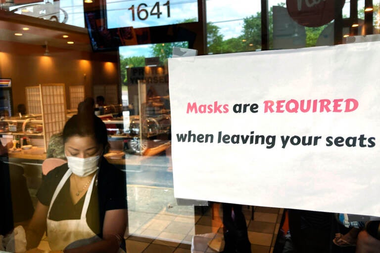 FILE - In this June 17, 2021, file photo, a sign requiring masks is displayed at a restaurant in Rolling Meadows, Ill. (AP Photo/Nam Y. Huh, File)