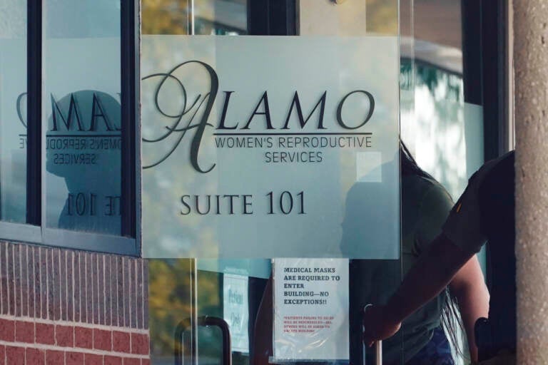 A woman enters Alamo Women's Reproductive Services, Thursday, Oct. 7, 2021, in San Antonio