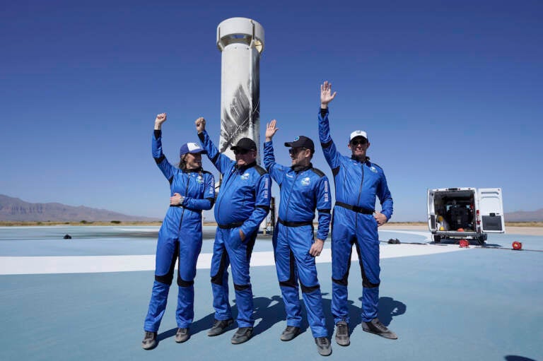 Blue Origin's New Shepard rocket latest space passengers from left, Audrey Powers, William Shatner, Chris Boshuizen, and Glen de Vries raise their hands during a media availability at the spaceport near Van Horn, Texas, Wednesday, Oct. 13, 2021