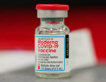 A vial of the COVID-19 vaccine from Moderna sits on a table top to be used in vaccinating employees in the first round of staff vaccinations at Rose Medical Center Wednesday, Dec. 23, 2020, in Denver