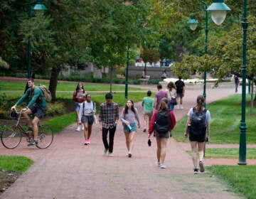 Students walk to and from classes on the Indiana University campus, Thursday, Oct. 14, 2021, in Bloomington, Ind. College communities such as Bloomington are exploring their options for contesting the results of the 2020 census, which they say do not accurately reflect how many people live there. (AP Photo/Darron Cummings)