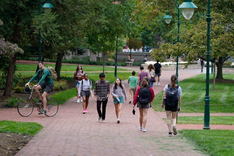 Students walk to and from classes on the Indiana University campus, Thursday, Oct. 14, 2021, in Bloomington, Ind. College communities such as Bloomington are exploring their options for contesting the results of the 2020 census, which they say do not accurately reflect how many people live there. (AP Photo/Darron Cummings)