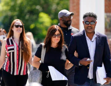 File photo: Former NFL players Ken Jenkins, right, and Clarence Vaughn III, center right, along with their wives, Amy Lewis, center, and Brooke Vaughn, left, carrie tens of thousands of petitions demanding equal treatment for everyone involved in the settlement of concussion claims against the NFL, to the federal courthouse in Philadelphia, Friday, May 14, 2021