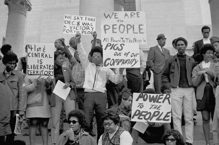 In this Dec. 11, 1969, file photo, demonstrators protest on the steps of the Los Angeles City Hall, against raids by police at Black Panther headquarters. (AP Photo/Wally Fong, File)