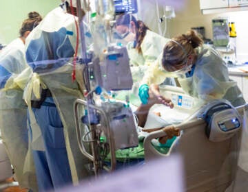Medical professionals pronate a patient in an ICU