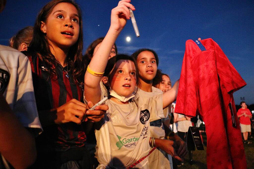 Mackenzie Ricco, 10, of Delran, tries to get soccer great Carli Lloyd to sign her shirt during a celebration of Carli Lloyd Day at Delran Community Park